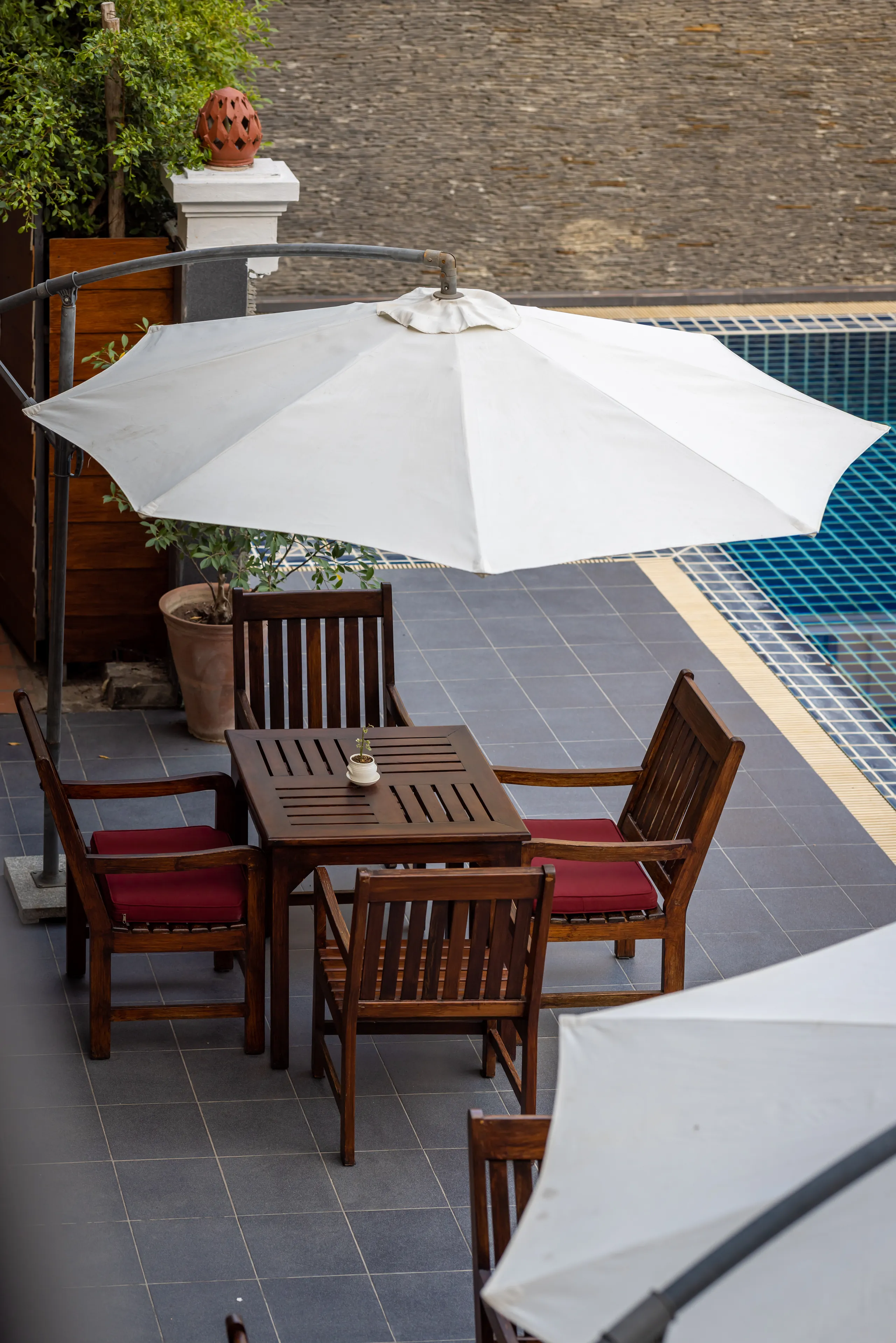 A shaded table for two on the pool terrace