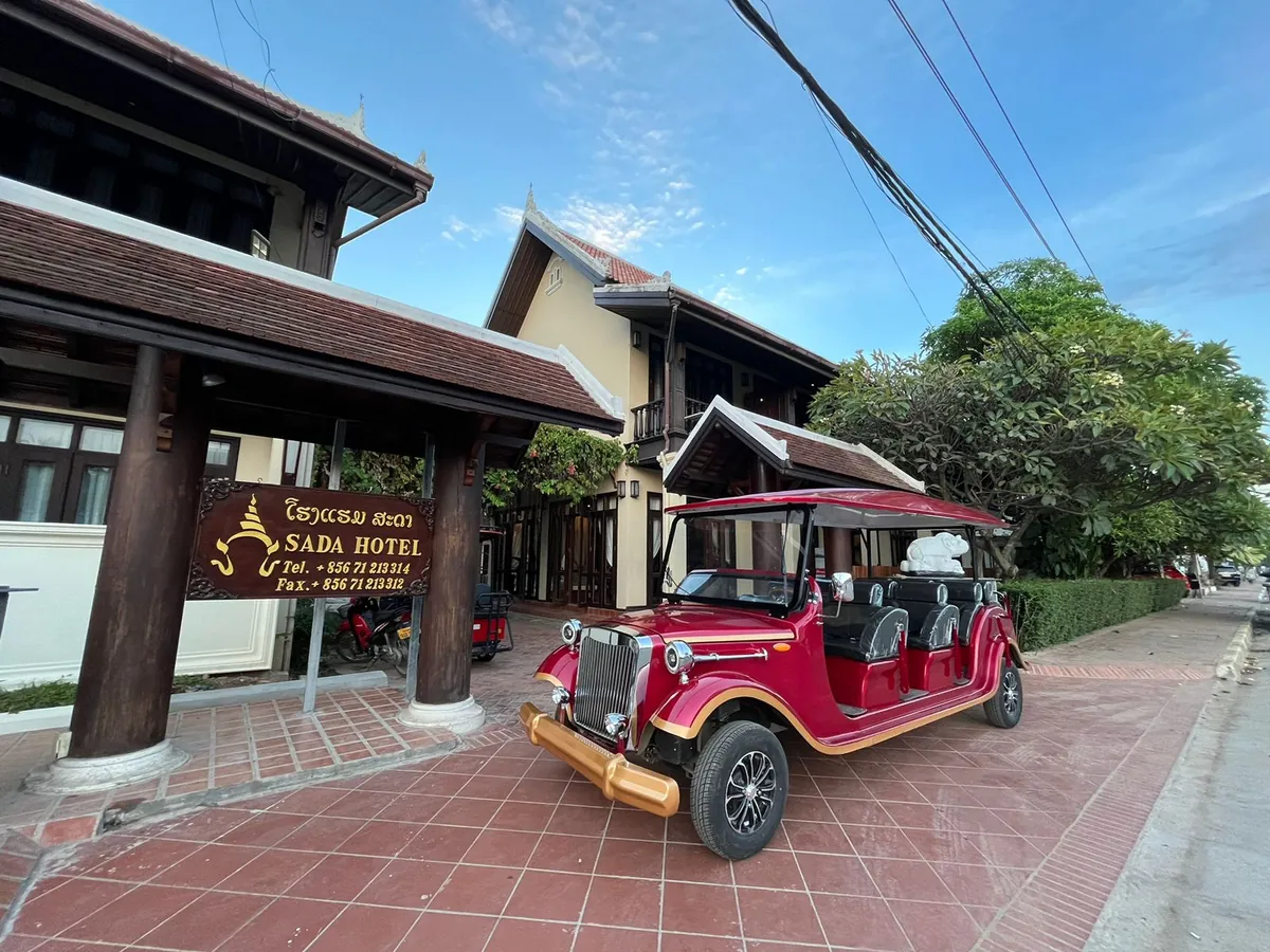 The hotel's red shuttle vehicle waiting outside the entrance