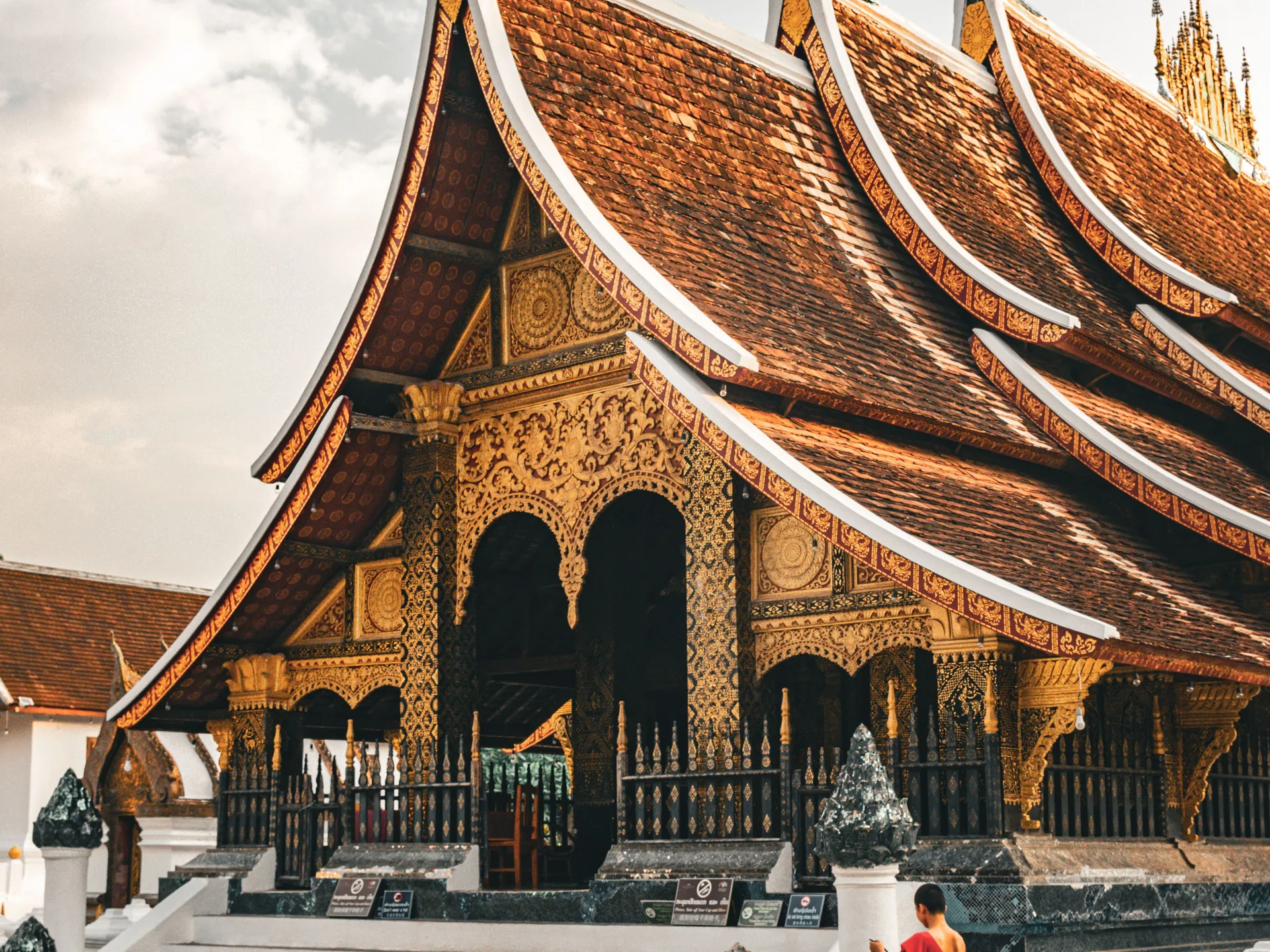 The sweeping tiled roofs and gilded façade of Wat Xieng Thong in Luang Prabang